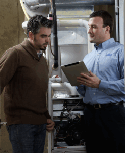 a homeowner discusses their hvac quote with a carrier factory authorized dealer technician